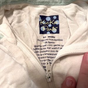 One piece white footie with mint green trim, from kickee pants. Gently used!